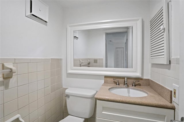 half bath featuring toilet, tile walls, and vanity