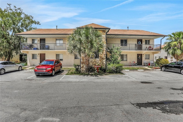 view of property with uncovered parking