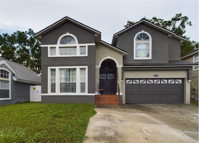 front of property with a front lawn and a garage