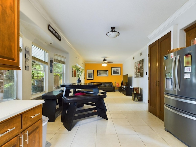 kitchen featuring stainless steel fridge with ice dispenser, ceiling fan, light tile patterned flooring, and ornamental molding