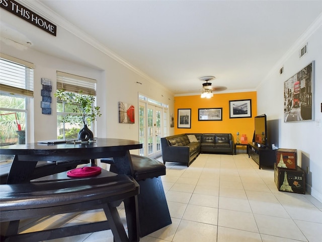 tiled living room with french doors, crown molding, and ceiling fan