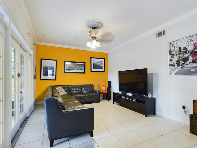 tiled living room with ceiling fan, crown molding, and french doors