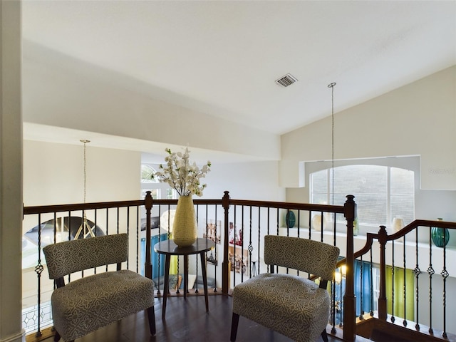 living area featuring wood-type flooring and vaulted ceiling