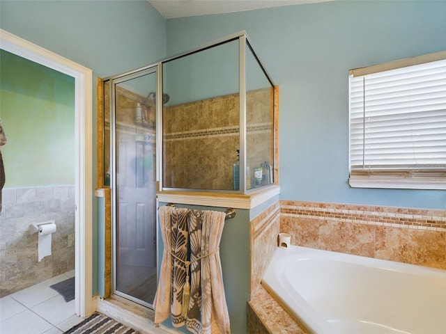 bathroom with tile patterned flooring and separate shower and tub