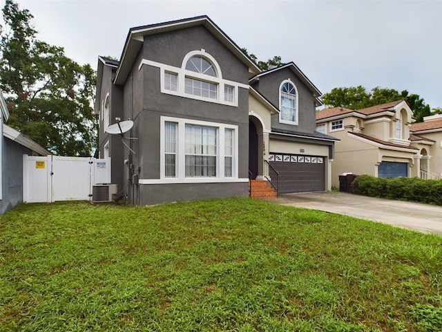 view of front of property featuring a garage, central air condition unit, and a front yard