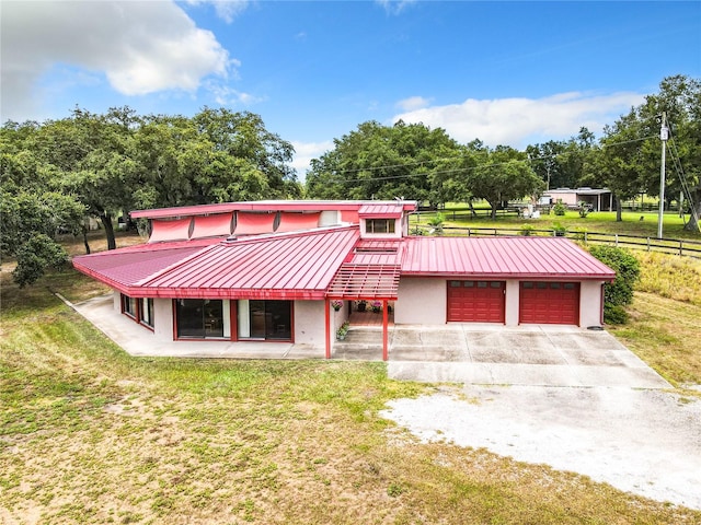 view of front of property featuring a garage and a front lawn