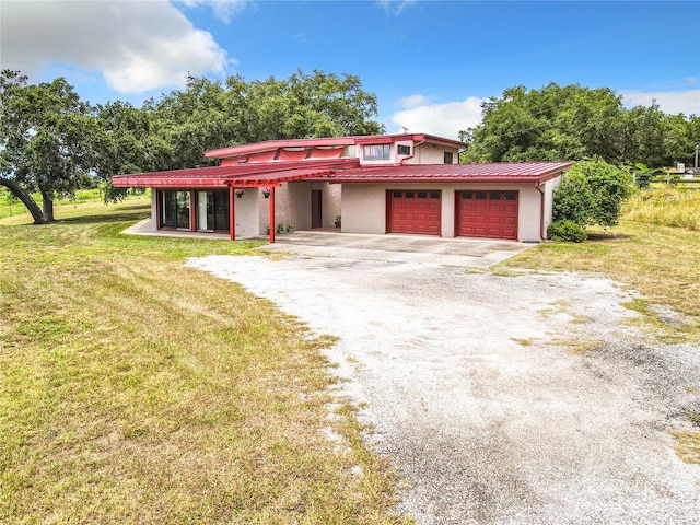 2741 Edwards Rd, Haines City, FL 33844 - view of front of property with driveway, a front lawn, a metal roof, and stucco siding