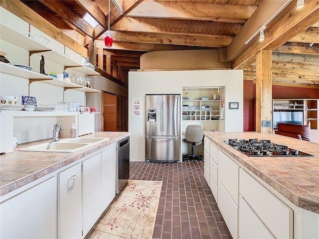 2741 Edwards Rd, Haines City, FL 33844 - kitchen featuring stainless steel appliances, open shelves, white cabinetry, light countertops, and beamed ceiling