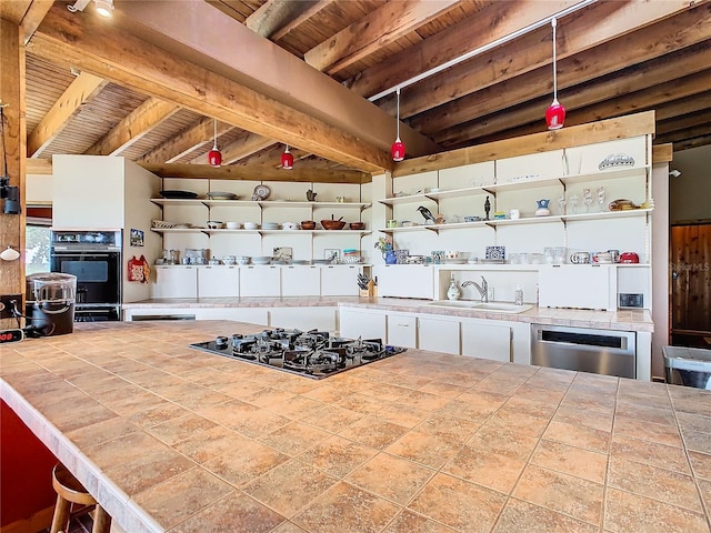 2741 Edwards Rd, Haines City, FL 33844 - kitchen with black appliances, tile countertops, open shelves, and a wooden ceiling with exposed beams