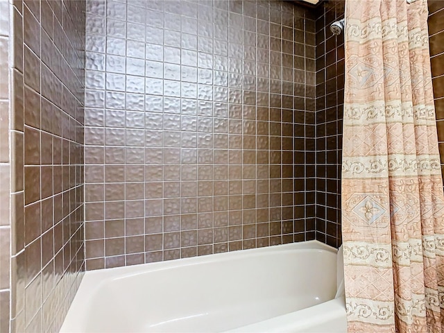 bathroom with shower / bath combo with shower curtain