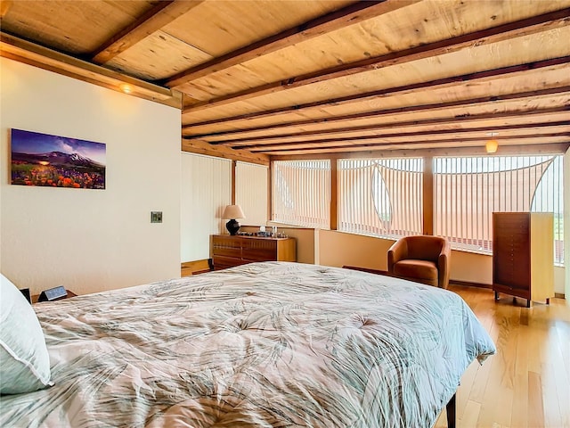 bedroom featuring beamed ceiling, light hardwood / wood-style floors, and wooden ceiling