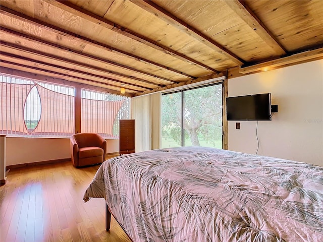 bedroom with beam ceiling, light hardwood / wood-style flooring, and wooden ceiling