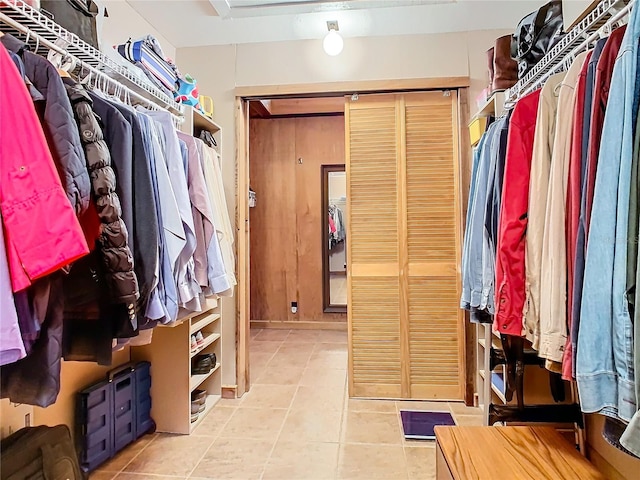 walk in closet with light tile patterned floors