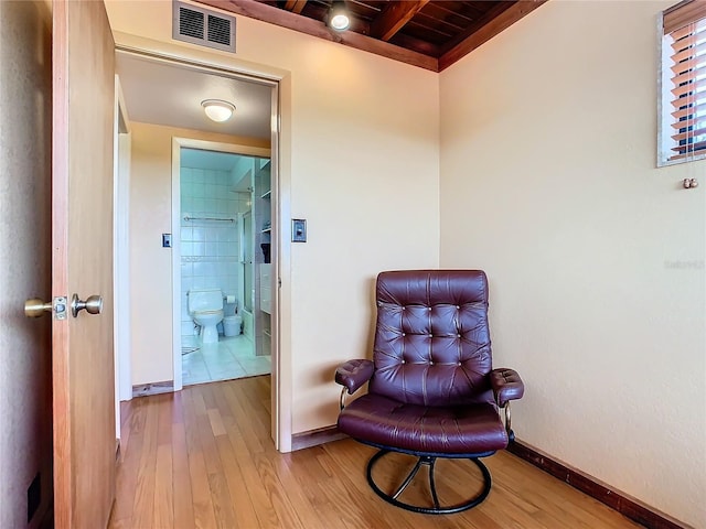 living area with beam ceiling, wood ceiling, and tile patterned floors