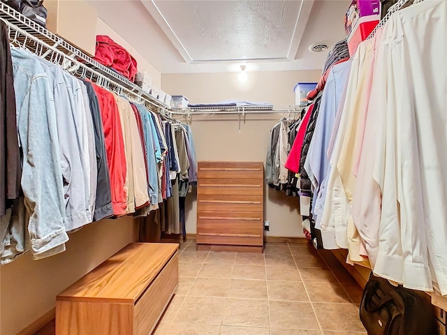 spacious closet with light tile patterned floors