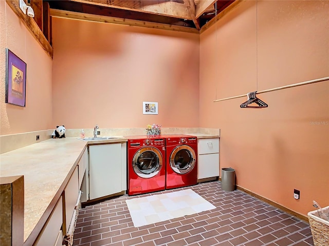 laundry area featuring sink, cabinets, and independent washer and dryer