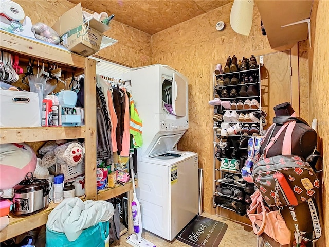 storage room with stacked washer and clothes dryer