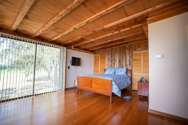2741 Edwards Rd, Haines City, FL 33844 - bedroom featuring wood finished floors, a wooden ceiling with exposed beams, and wooden walls