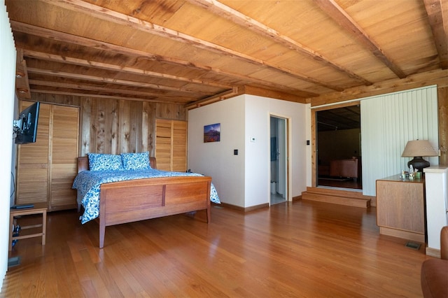 2741 Edwards Rd, Haines City, FL 33844 - bedroom with wood finished floors, wood walls, and a wooden ceiling with exposed beams