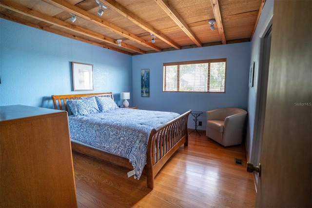 2741 Edwards Rd, Haines City, FL 33844 - bedroom featuring wood finished floors, a wooden ceiling with exposed beams, and rail lighting