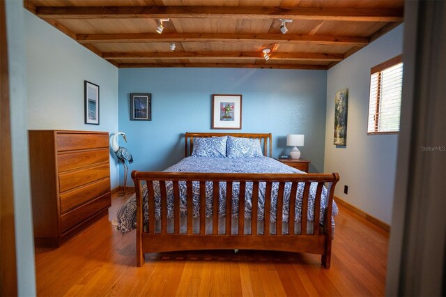 2741 Edwards Rd, Haines City, FL 33844 - bedroom with a wood ceiling with exposed beams and light wood finished floors