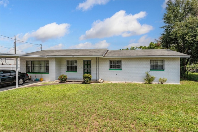 ranch-style house with a carport and a front yard