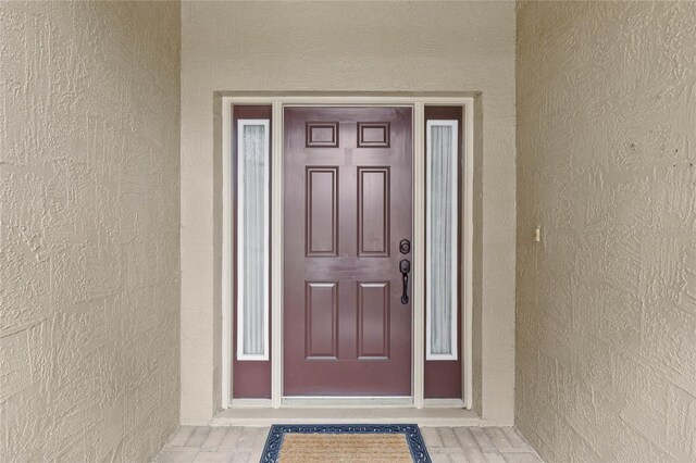 doorway to property with stucco siding