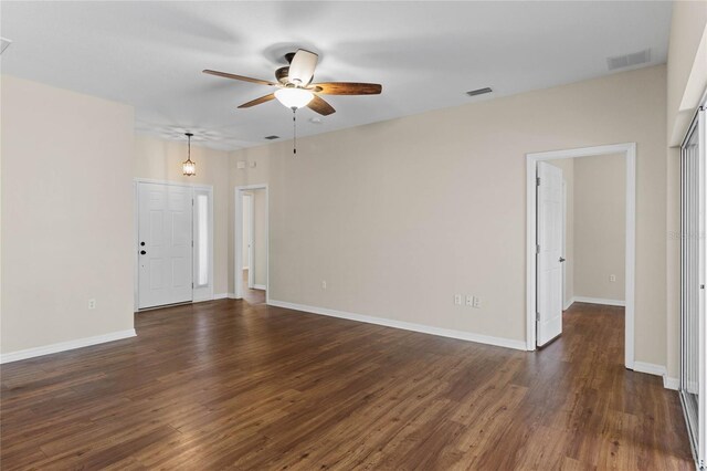 spare room with dark hardwood / wood-style flooring and ceiling fan