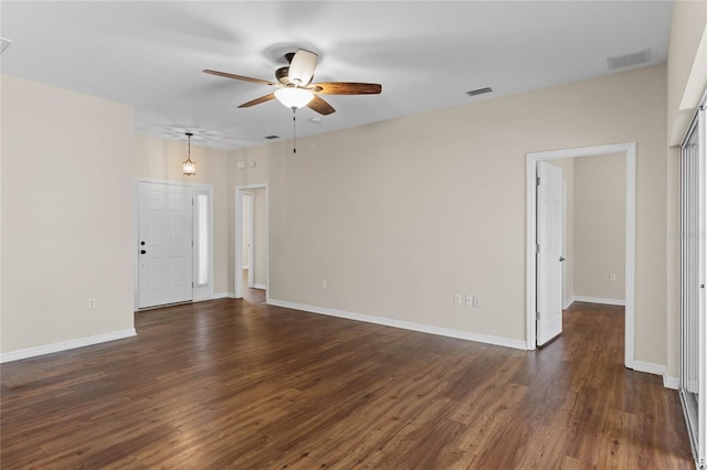 unfurnished living room with visible vents, baseboards, dark wood-type flooring, and ceiling fan