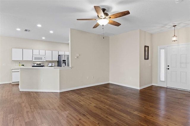 kitchen with visible vents, dark wood-type flooring, ceiling fan, appliances with stainless steel finishes, and white cabinetry