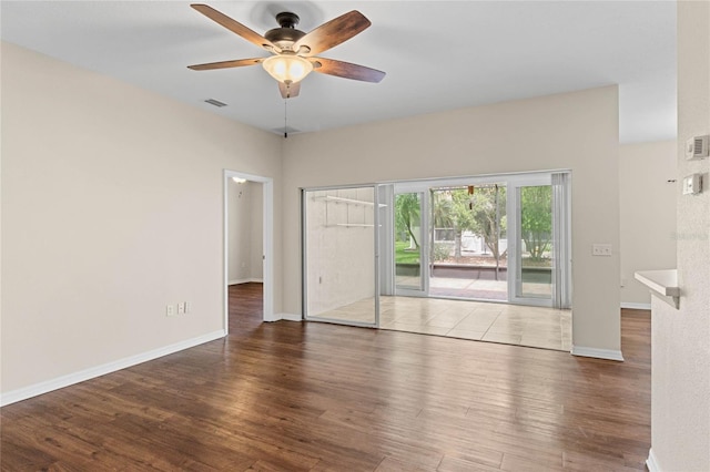 interior space with visible vents, baseboards, ceiling fan, and wood finished floors