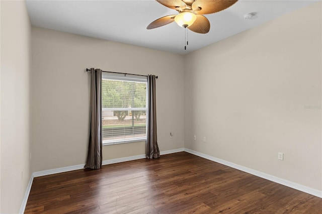 spare room featuring dark wood-type flooring and ceiling fan