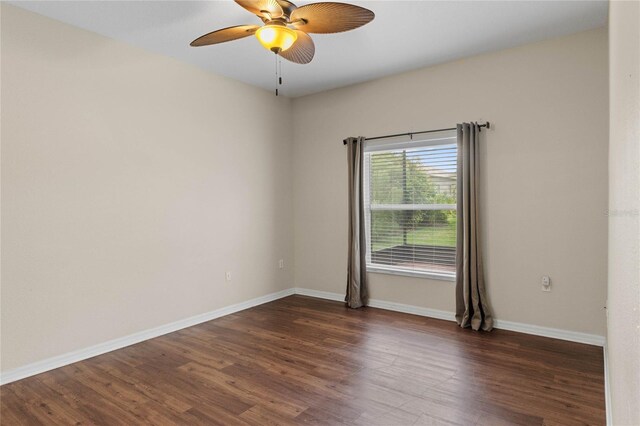 unfurnished room featuring ceiling fan and dark hardwood / wood-style flooring