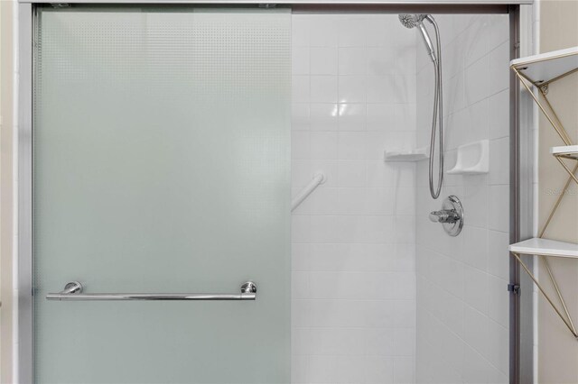 bathroom featuring a shower with door