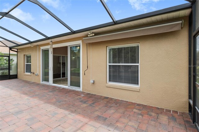 rear view of house featuring a patio and a lanai