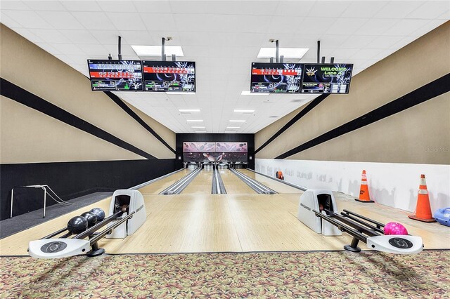 rec room with a bowling alley and a drop ceiling