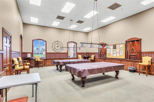 recreation room featuring carpet, visible vents, a wainscoted wall, a high ceiling, and pool table