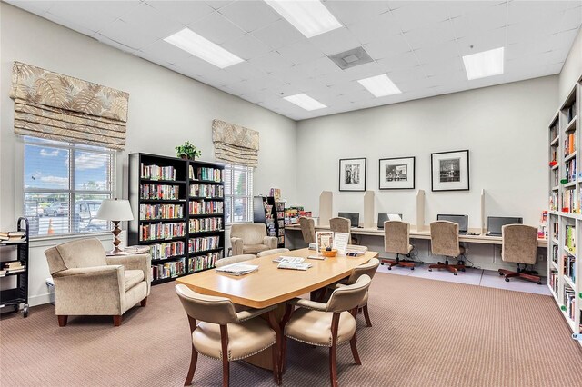 office area with carpet flooring, plenty of natural light, and a paneled ceiling