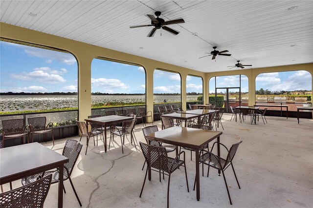 view of patio with outdoor dining area and ceiling fan
