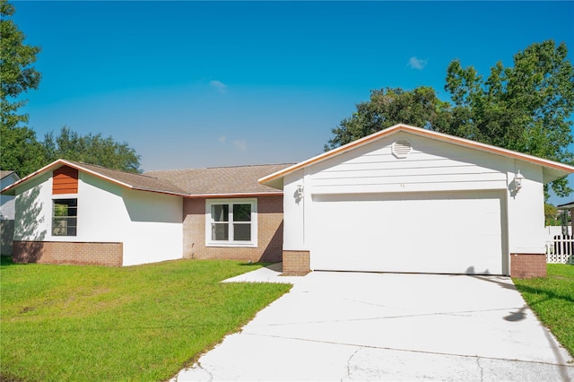 single story home with a front lawn and a garage