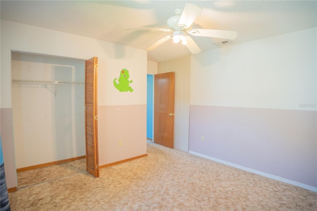 unfurnished bedroom with carpet floors, ceiling fan, and a closet