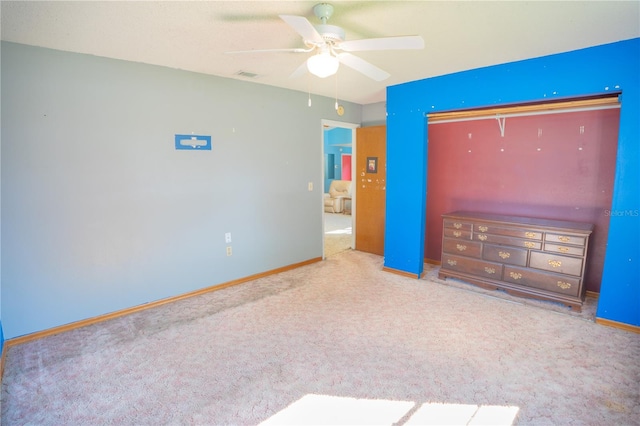 unfurnished bedroom featuring ceiling fan and carpet flooring