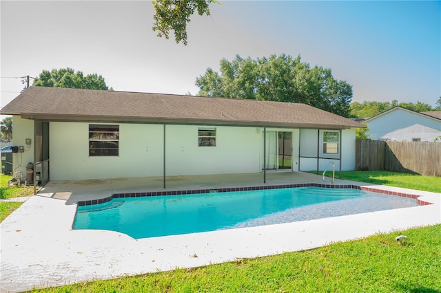 view of swimming pool featuring a patio and a yard