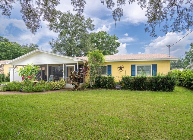 ranch-style home with a front lawn