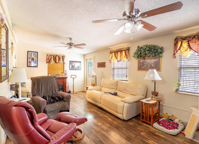 living room featuring hardwood / wood-style flooring, a textured ceiling, and ceiling fan