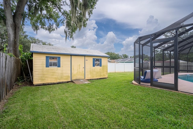 exterior space with a fenced in pool, a lanai, a fenced backyard, and an outdoor structure