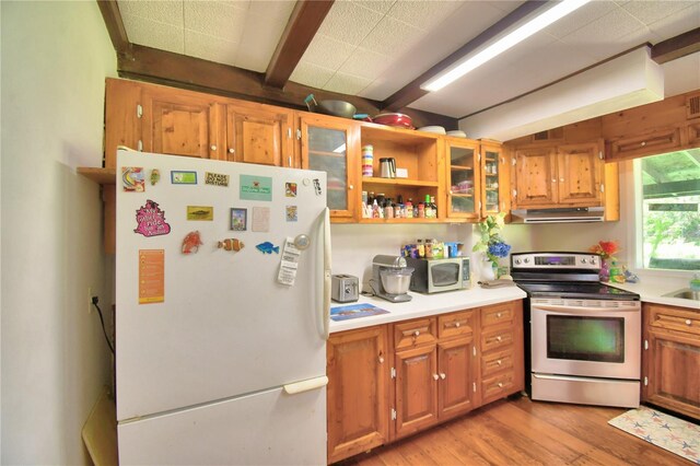 kitchen with light hardwood / wood-style floors, beam ceiling, and white appliances