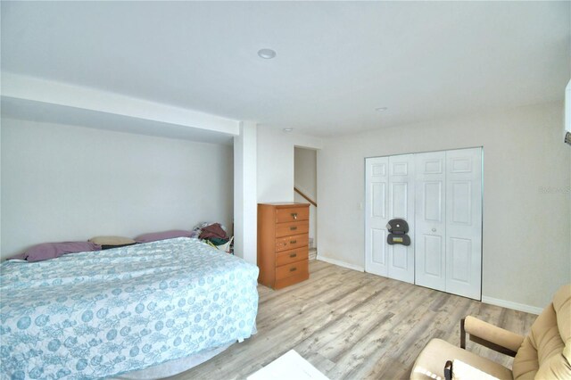 bedroom featuring light hardwood / wood-style floors and a closet