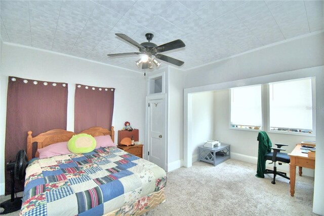 bedroom featuring ceiling fan, carpet, and ornamental molding