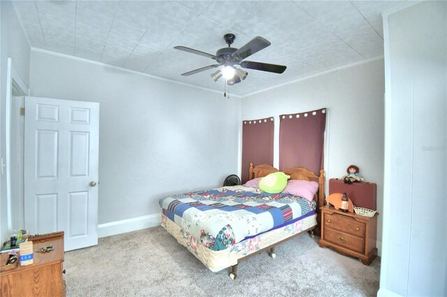 carpeted bedroom with ceiling fan and crown molding